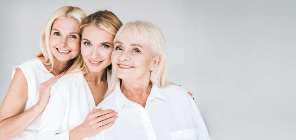 three beautiful women of different ages embracing